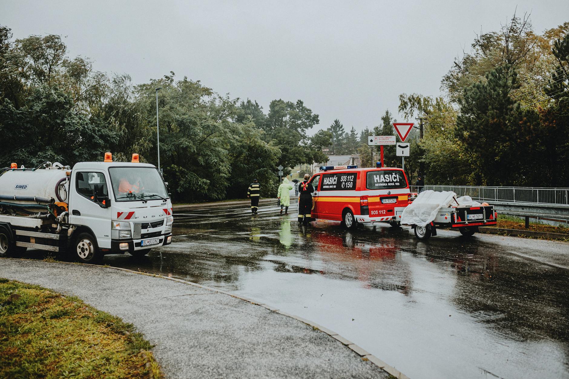 emergency response vehicles on rainy road